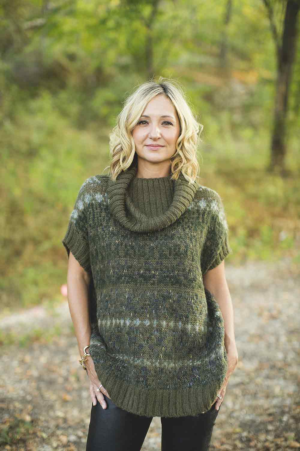 A woman stands in woods. Team member Jamie Shackelford, a veteran, is one of many honored for Veterans Day.
