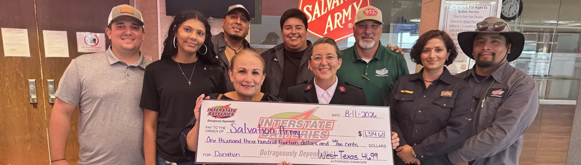 IB of West Texas and Salvation Army team members holding a large check together