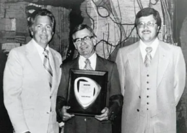 Interstate Batteries 1978 historical milestone marking the retirement of founder John Searcy and Norm Miller becoming President