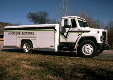 Interstate Batteries 1989 history milestone celebrating international expansion into Canada with a classic delivery route truck