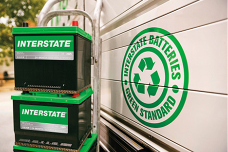 Interstate Batteries in front of a recycling logo on a truck