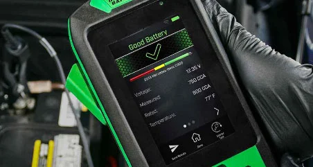 Digital display screen of the Interstate Batteries Pulse tester showing car battery health diagnostics and test results