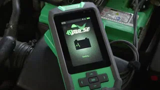 A technician quickly navigating the digital interface of the Interstate Batteries Pulse battery analyzer during a vehicle inspection