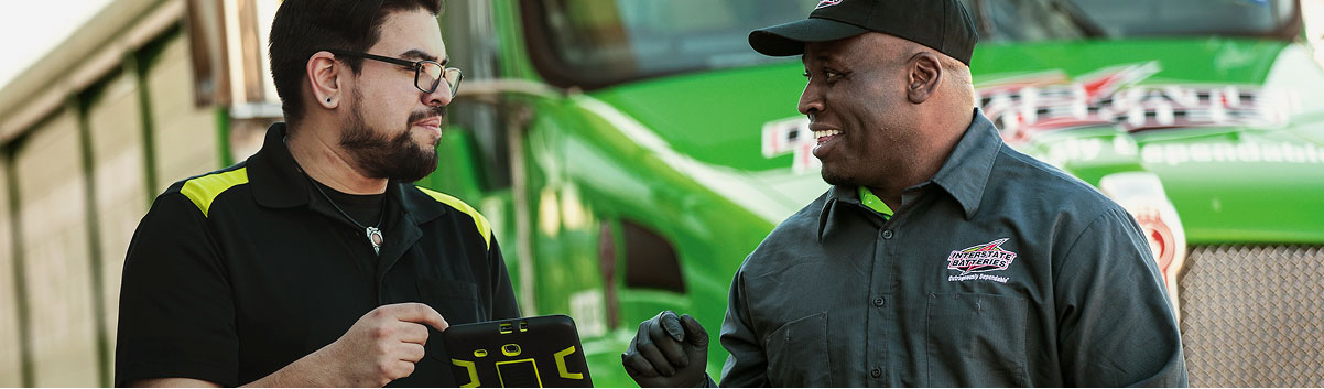 Mechanics in front of an Interstate truck