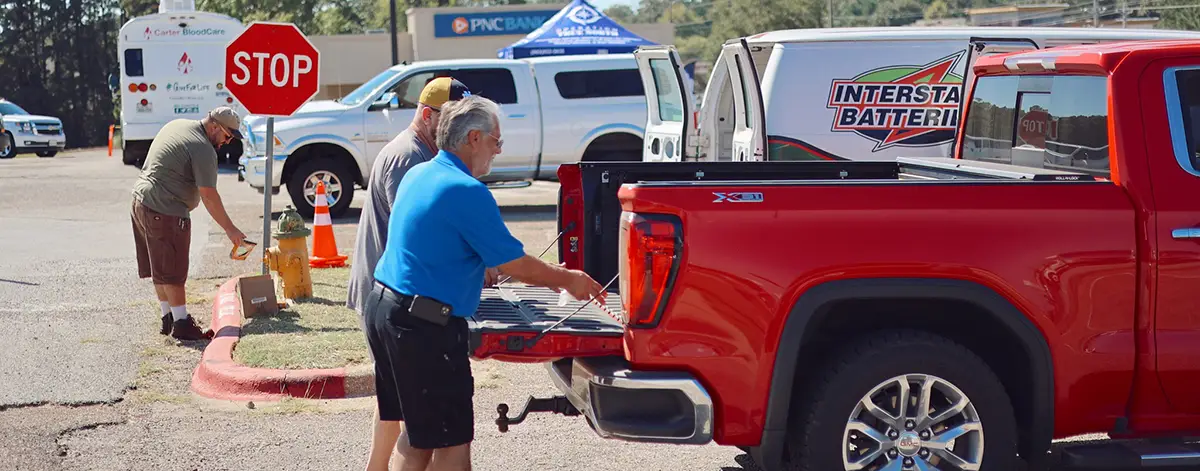 Interstate All Battery Center of Longview employees unload a truck during a recycling event
