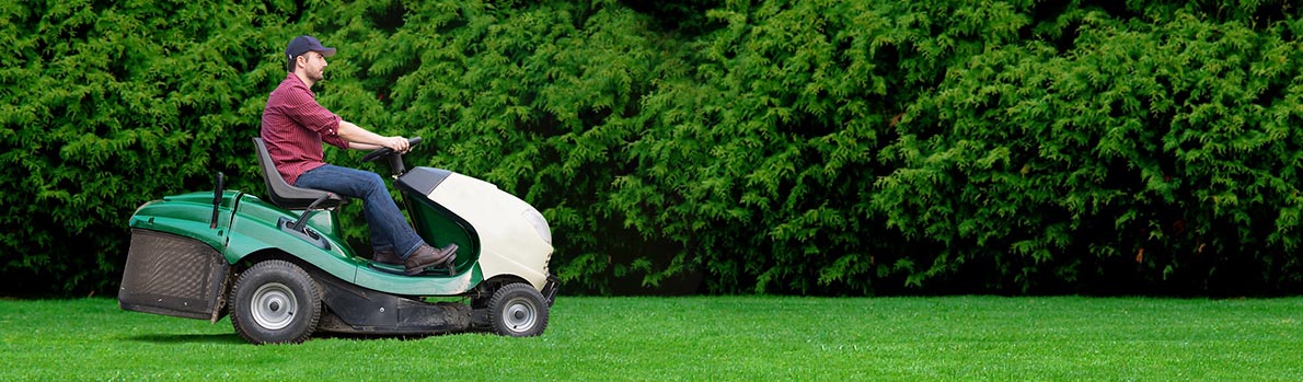 image of person on riding lawnmower