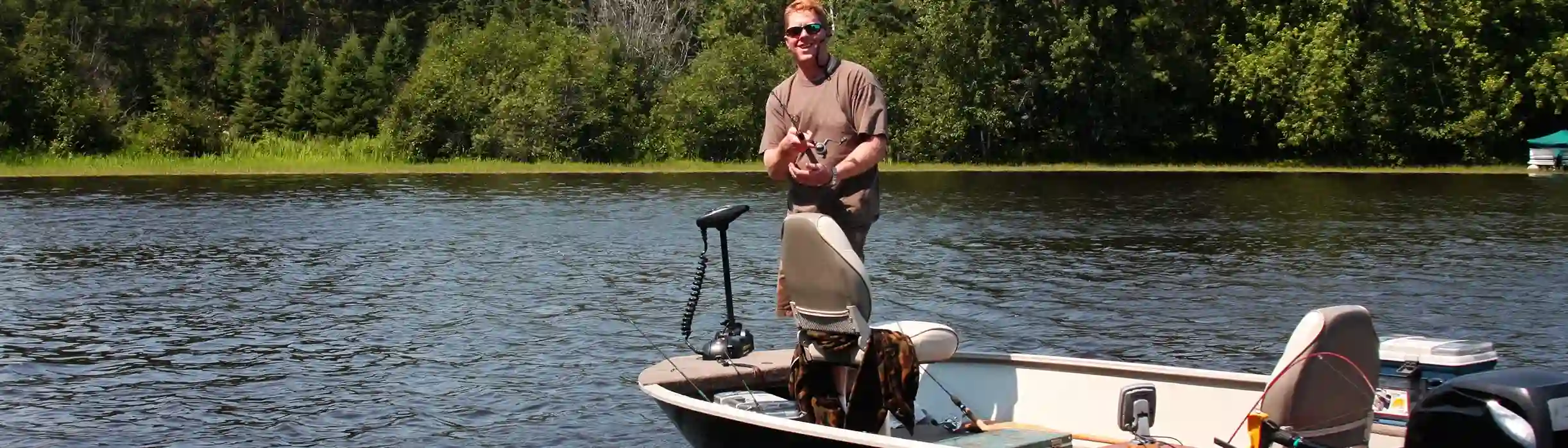 Boat in water with Interstate Marine Dual Purpose Battery and Lithium battery overlaid on photo