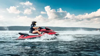 Person riding jetski across the ocean