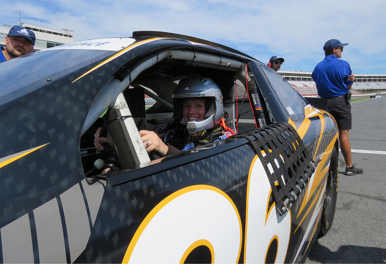 Semper Fi service member in driver's seat in Nascar Ride & Drive experience