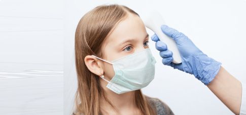 Girl getting temperature taken with digital thermometer