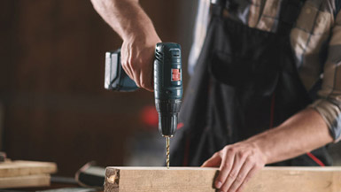 Man Drilling into Wood