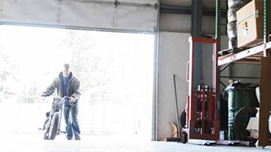 Man Storing Vehicle In Garage