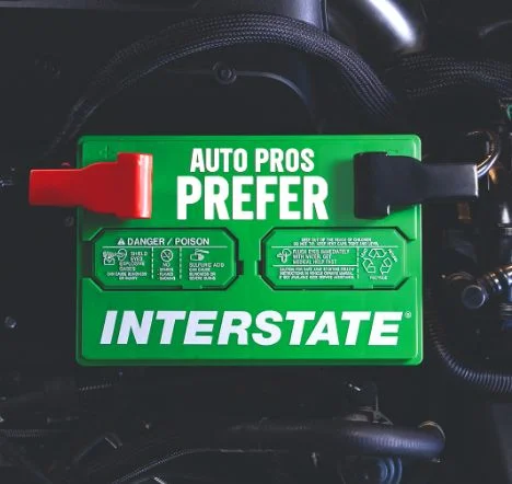 Interstate car battery installed in vehicle engine bay