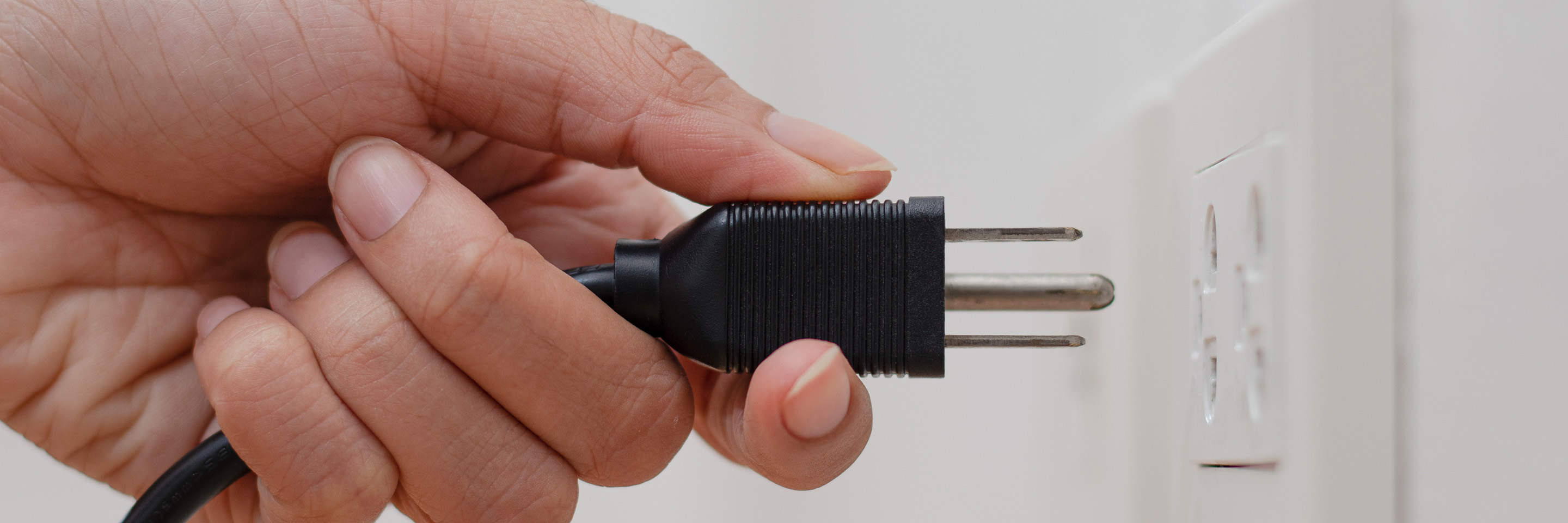 plug going into a wall outlet