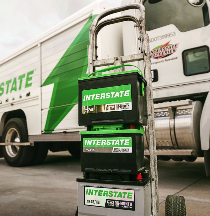 Interstate Batteries products on a dolly in front of a delivery truck