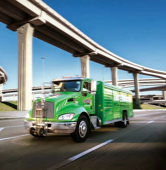 Interstate Batteries delivery truck driving on a highway interchange