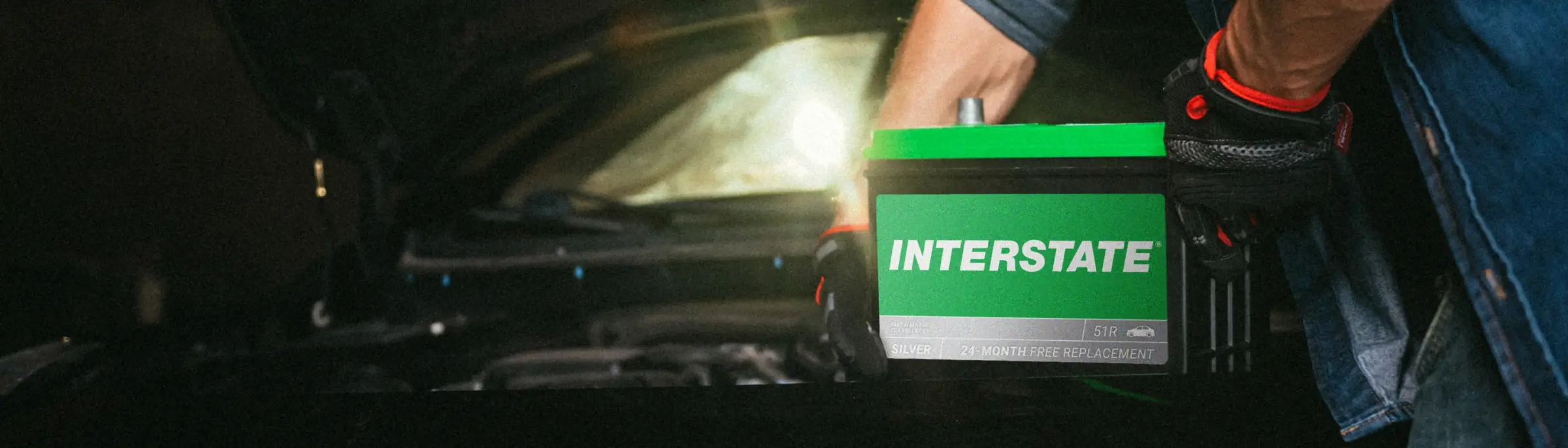 Interstate Battery being installed in a car