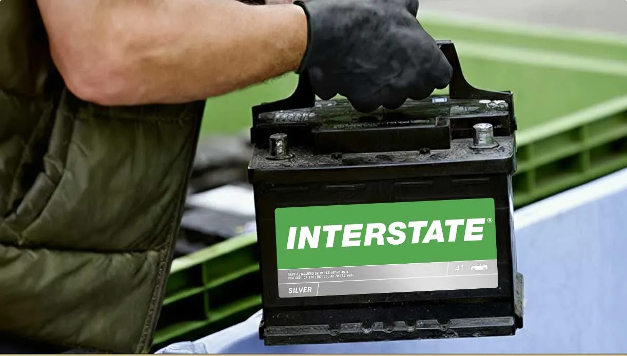 person recycling a car battery