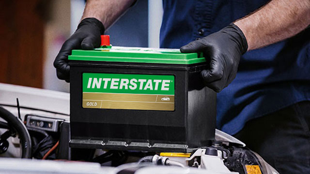 Tech installing an Interstate battery