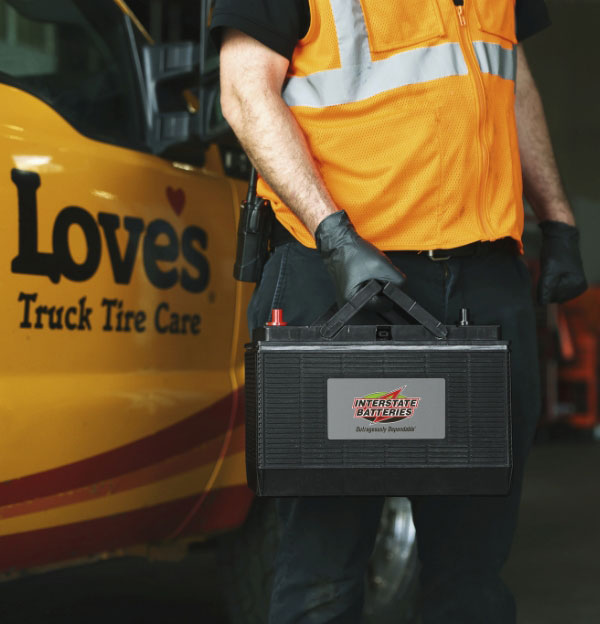 Love's technician carrying a battery